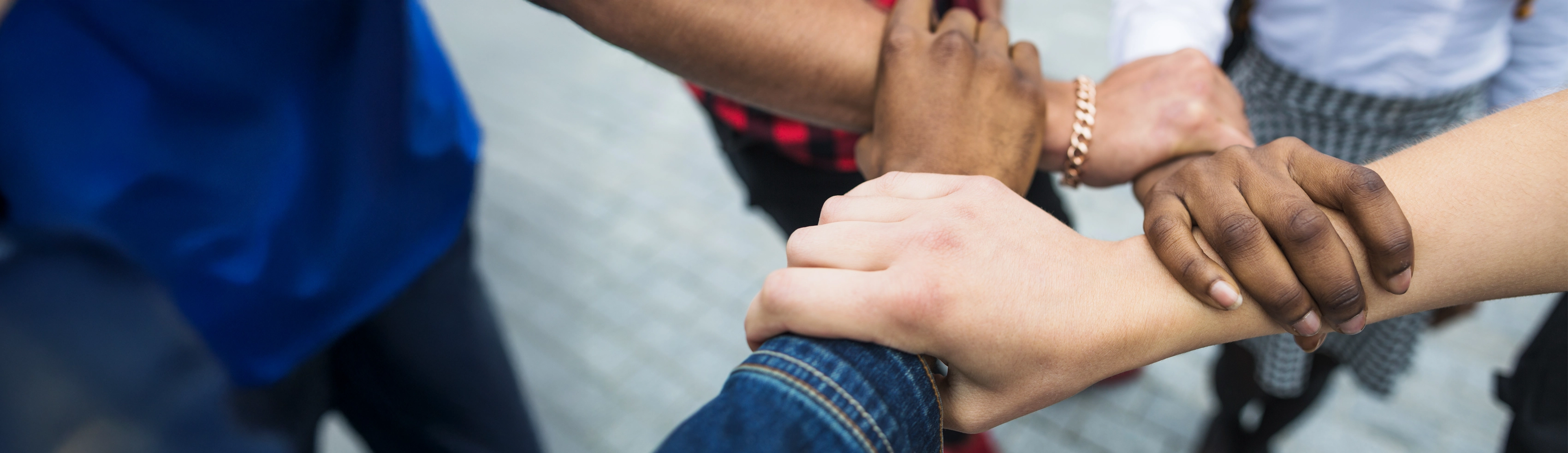 Hands from many different backgrounds joined together